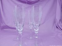Four Bohemia Crystal Thistle pattern champagne flutes standing upright