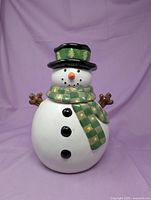 Front view of ceramic snowman cookie jar with lid in place