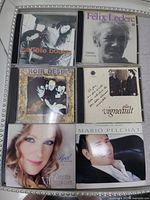 Six CDs featuring Isabelle Boulay, Félix Leclerc, Noir Désir, Gilles Vigneault, Annie Villeneuve, Mario Pelchat