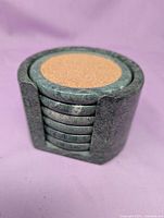 stacked coasters inside stone holder, frontal view