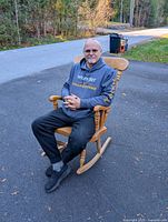 Front view of the wooden rocking chair with person seated