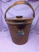 Front view of leather-covered ice bucket with lid and handle raised