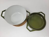 pot with lid removed showing white interior and olive exterior