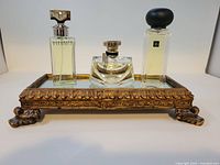 Tray displayed with perfume bottles for scale