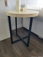 Side view showing full table with mother-of-pearl top and metal base