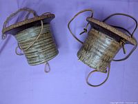 Side view of both planters showing glaze, ribbing, and hanging cords