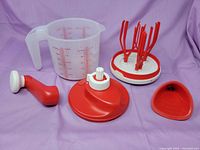 All components laid out: jug, rotary lid, handle, beaters, spout