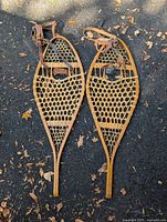 Full view of both wooden snowshoes showing overall condition