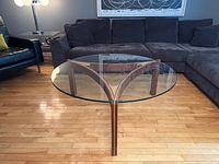 Full view of round glass top and rosewood legs