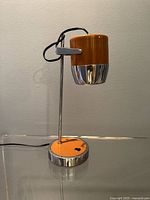 Front view of orange and chrome desk lamp