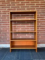 Front view showing entire teak bookcase and four shelf levels