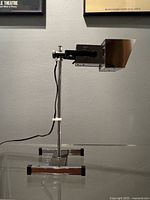 Full side view of chrome table lamp on base