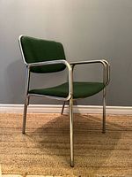 Front angled view showing chrome frame and green upholstery