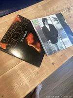 Both album jackets side by side on tabletop