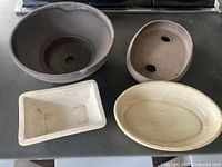 All four bonsai pots in assorted shapes and colours