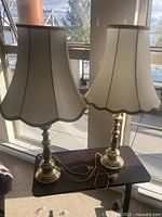 Front view of both brass lamps with shades