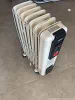 Full view of oil-filled radiator heater with wire guard and casters