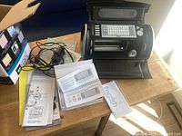 Cricut Create machine open with accessories, manuals, CD, power cord