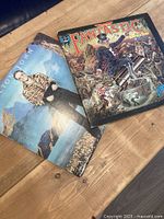 Both album covers on table