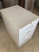 Cabinet exterior showing two drawers, light grey finish, integrated handles and label holders