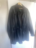 Front view of Danier black leather jacket on hanger