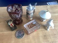 All items in lot: crystal vase, crystal box, beer stein, sugar bowl, lacquer box, hanging plaque, animal figurine