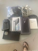 Group view of phone boxes, LG phone, mini keyboard, cables and accessories