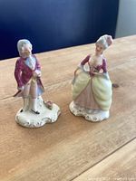 Front view of both porcelain figurines