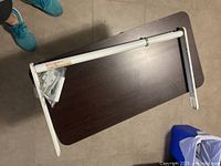 Overall view of white pull-up bar with swinging arms lying on table