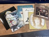 All six LP covers displayed on table