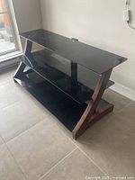 Front angled view showing overall stand and glass shelves