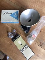 Group shot showing Kalimar exposure meter box, flash reflector, GE M3 bulbs box, loose bulbs, large bulb in bag