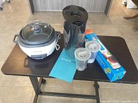 All items on table: rice cooker, water filter pitcher, filters, SodaStream box