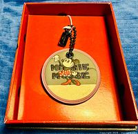 Front of round Minnie Mouse hangtag inside box