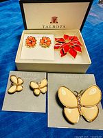 Overview of all brooches and earrings in Talbots box, showing six items on original cards