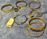 Overview of eight jewellery pieces on cloth surface
