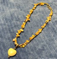 Full view of necklace showing bead pattern and heart pendant