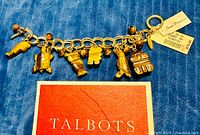 Full view of bracelet with all charms, hang tag and box