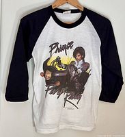 Full view of T-shirt on hanger showing design and sleeve style