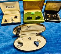 All four boxed cufflink sets displayed