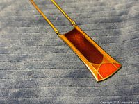 Front view of enamel pendant on chain