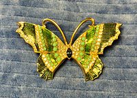 Front view showing enamel, rhinestones, stones and overall design