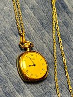 Close view of Timex pendant watch showing dial and chain detail