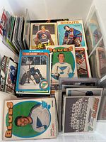 Stacked vintage hockey cards in box with St. Louis Blues, Jets, Scouts visible