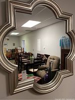 Front view of quatrefoil resin framed mirror mounted on wall