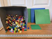 Bulk LEGO bricks spilling from fabric bin with ruler for scale