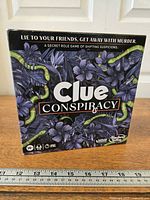 Front of Clue Conspiracy game box showing artwork and title