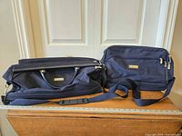 Front view of both bags showing size difference and navy fabric