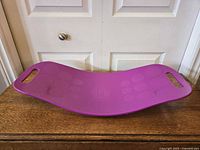 Top view of purple Simply Fit balance board showing textured circles and handholds