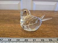 Left profile of Swarovski crystal bird showing facets and ruler for scale